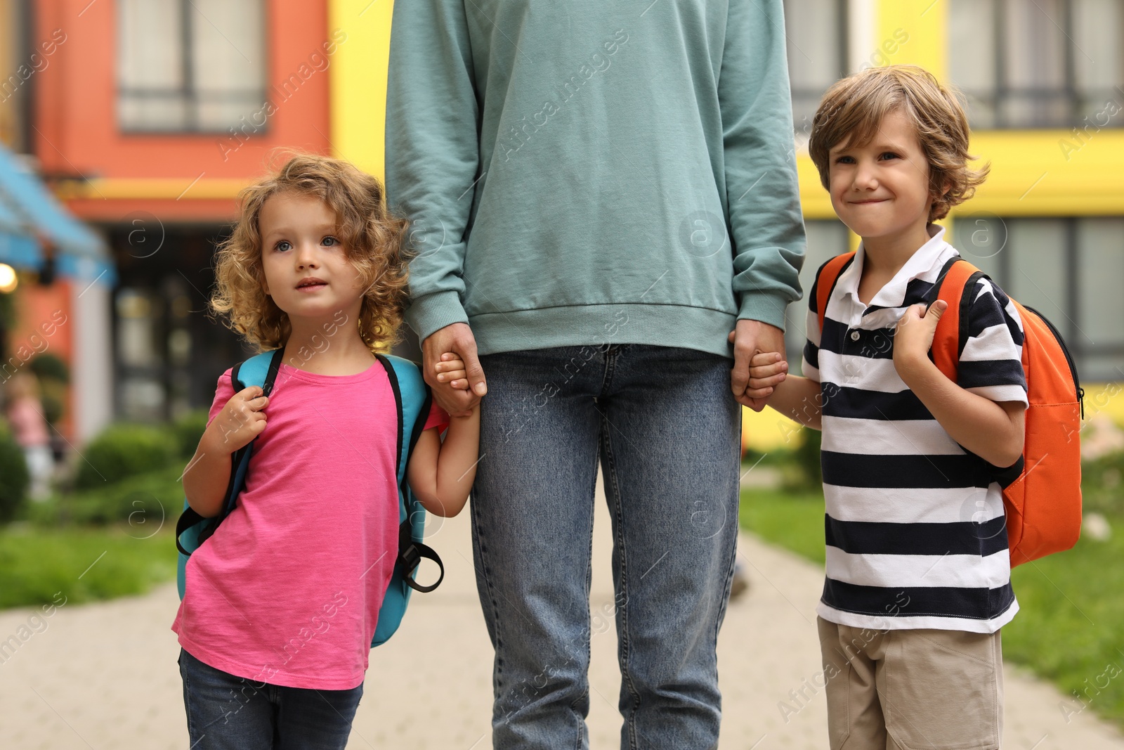 Photo of Woman and her children on their way to kindergarten outdoors