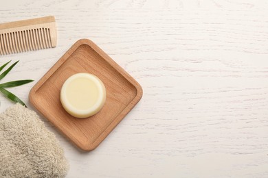 Photo of Flat lay composition with solid shampoo bar on white wooden table, space for text