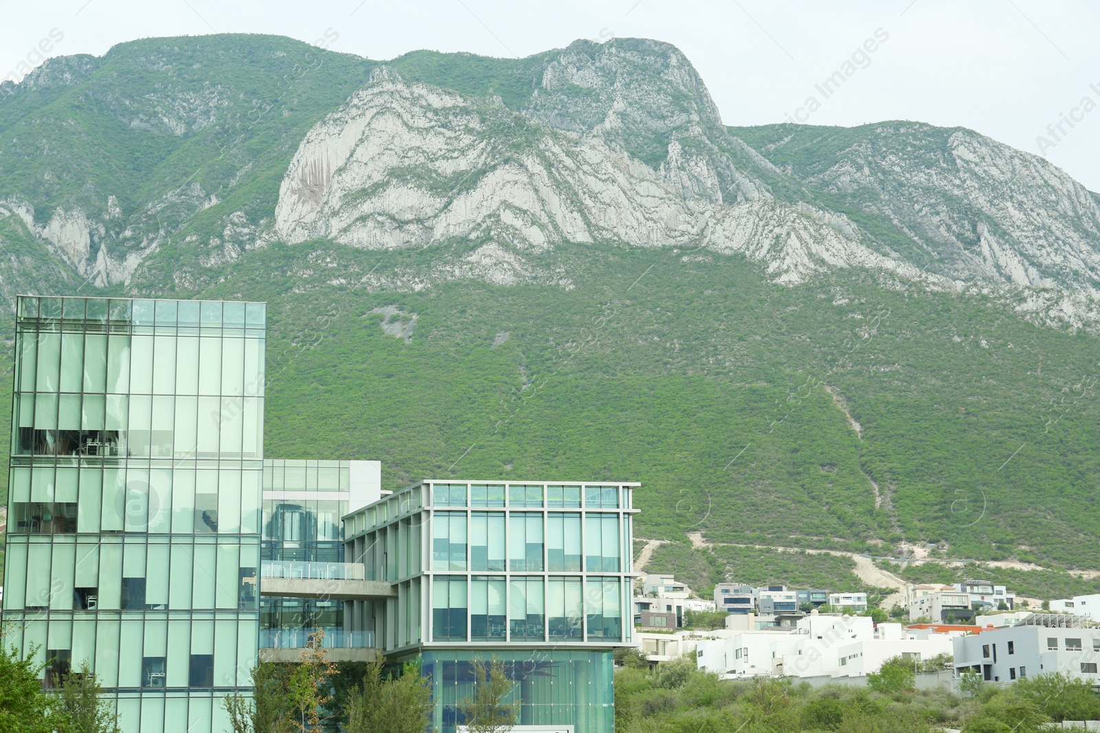 Photo of City near beautiful mountain landscape under blue sky