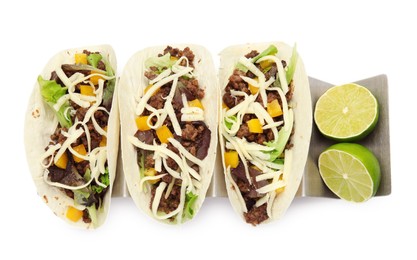 Delicious tacos with fried meat, cheese and lime on white background, top view