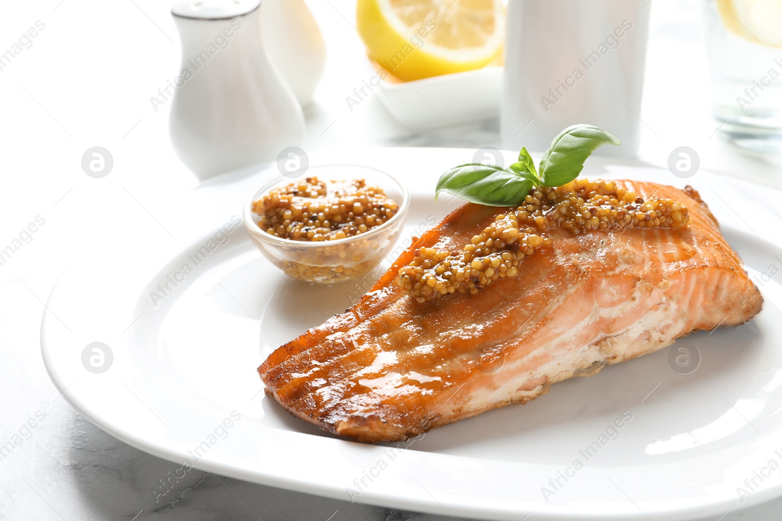 Photo of Tasty cooked salmon with mustard on plate, closeup