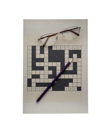Photo of Blank crossword, eyeglasses and pencil on white background, top view