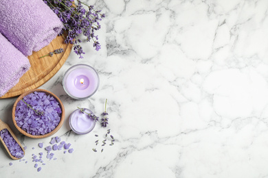 Photo of Cosmetic products and lavender flowers on white marble table, flat lay. Space for text