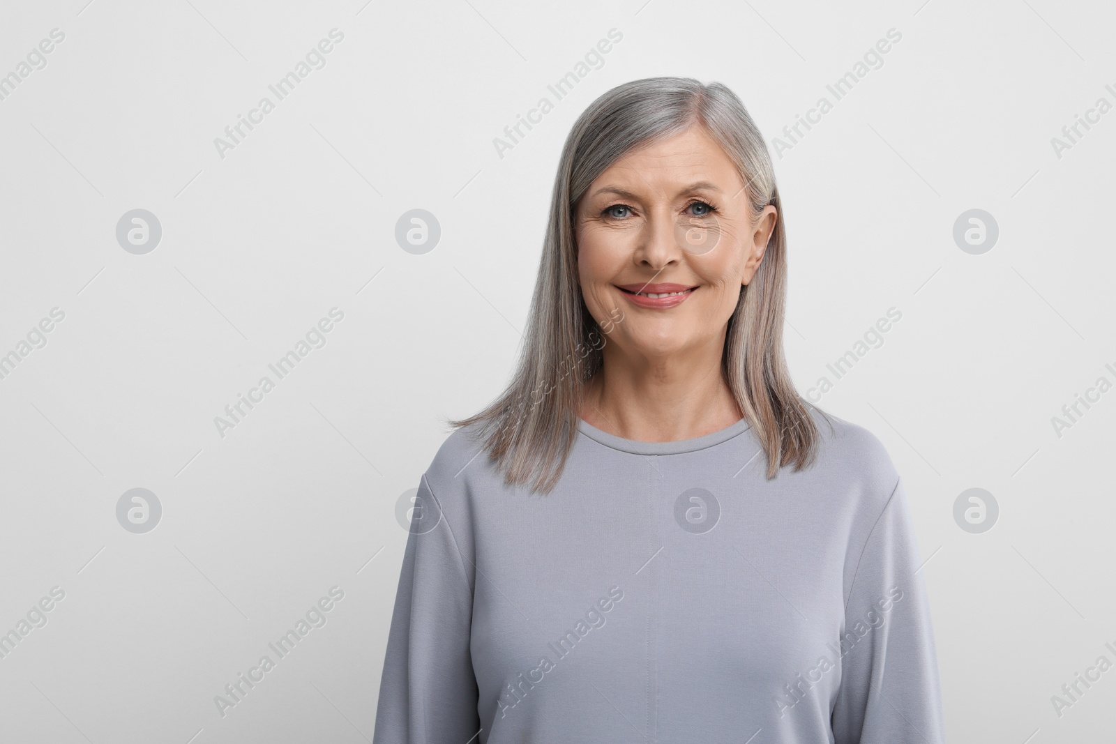 Photo of Portrait of beautiful senior woman on white background. Space for text