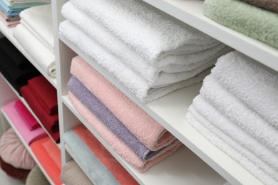 Photo of Bed linens and towels on shelves in shop