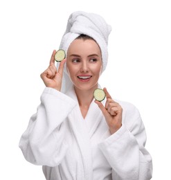 Photo of Beautiful woman in bathrobe with pieces of cucumber on white background