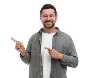 Special promotion. Smiling man pointing at something on white background