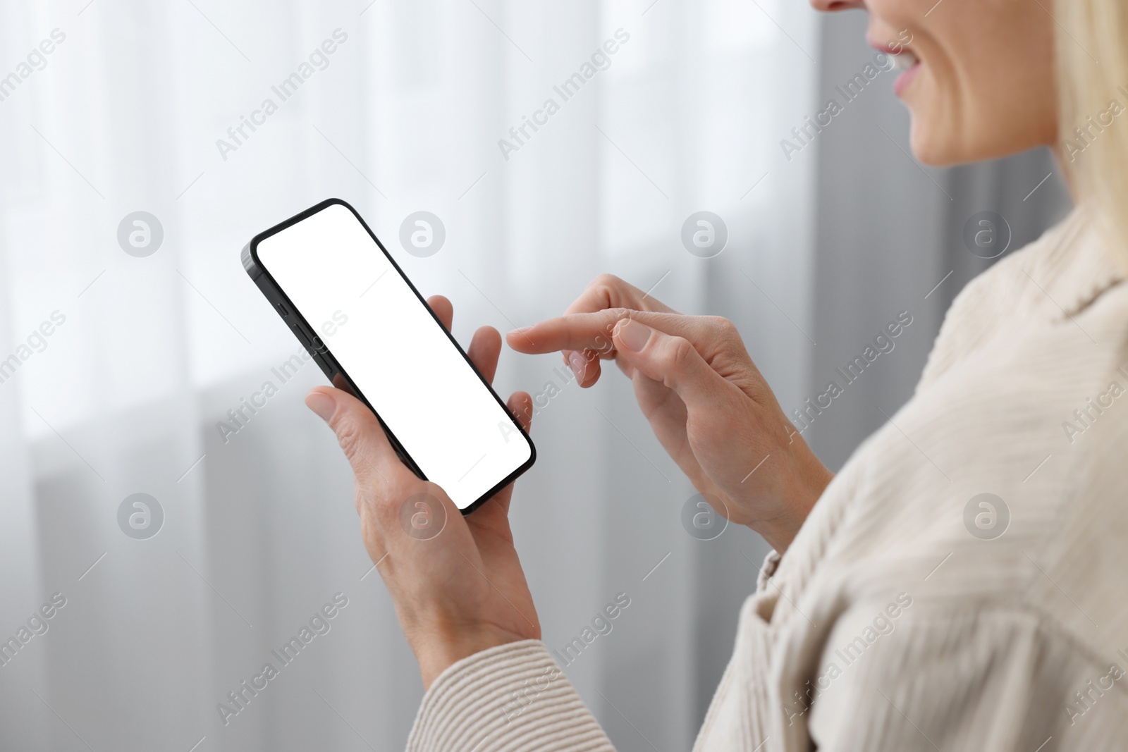 Photo of Woman using smartphone at home, closeup. Space for text