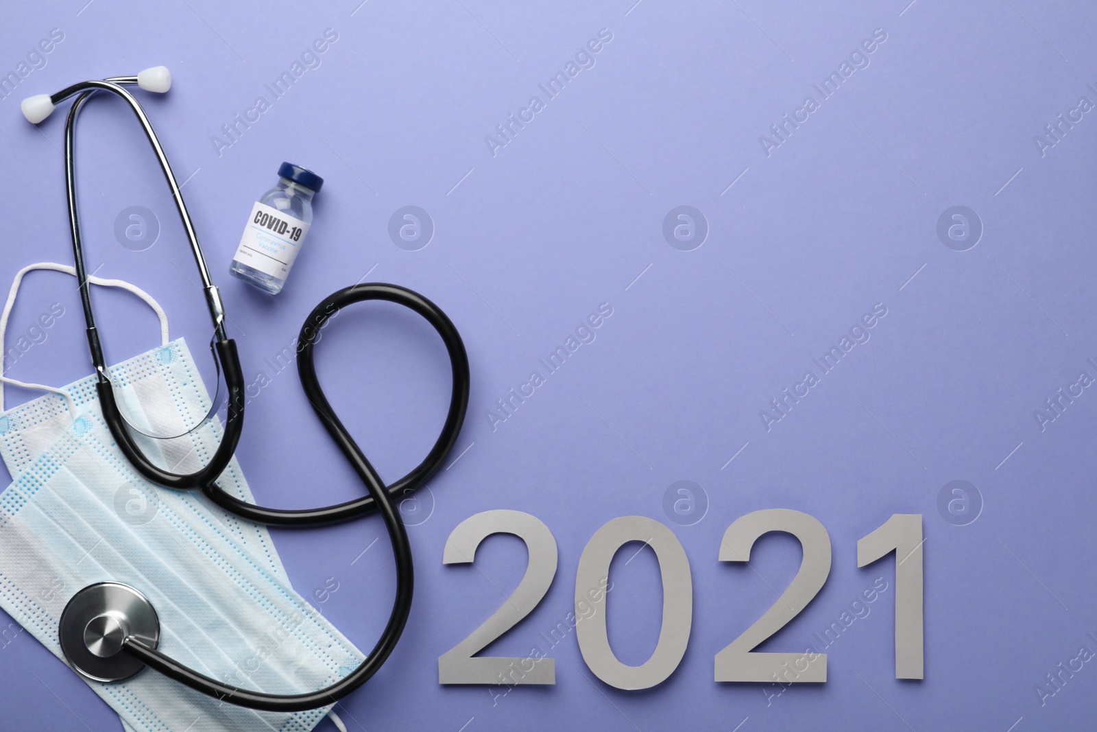 Photo of Flat lay composition with coronavirus vaccine on and number 2021 violet background, space for text