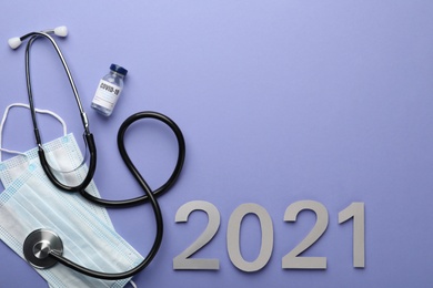 Photo of Flat lay composition with coronavirus vaccine on and number 2021 violet background, space for text