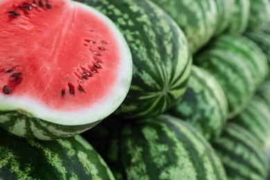 Photo of Delicious whole and cut watermelons as background, closeup