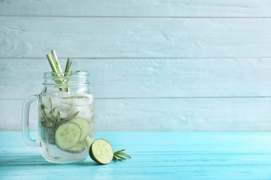 Photo of Natural lemonade with cucumber in mason jar on wooden table