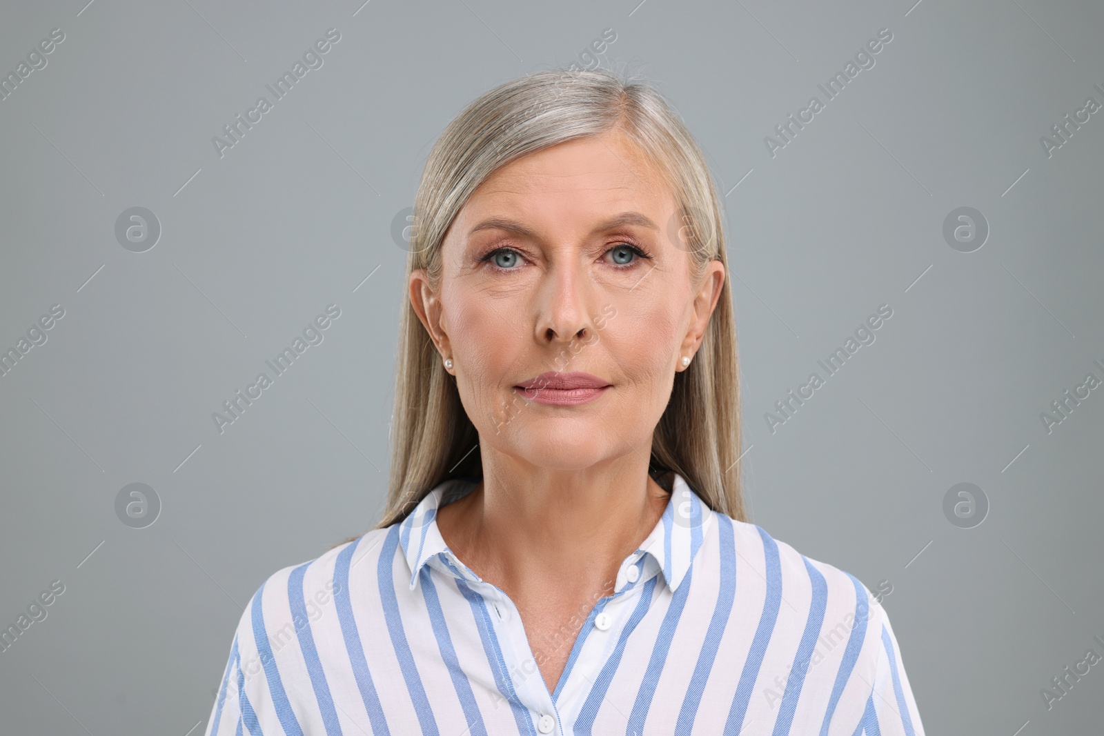 Photo of Portrait of beautiful senior woman on light grey background