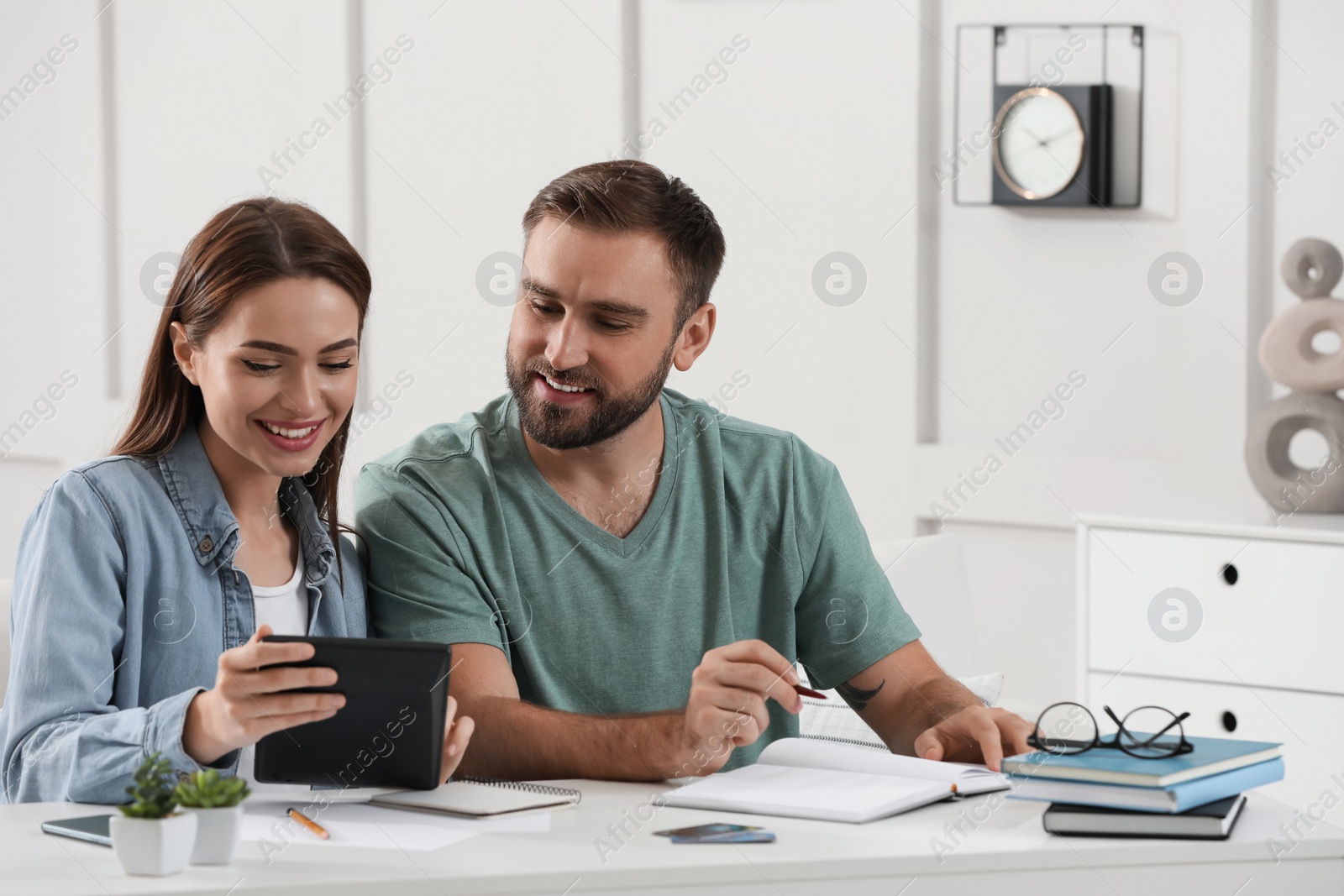 Photo of Young couple discussing family budget at home