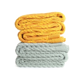 Different stylish knitted plaids on white background