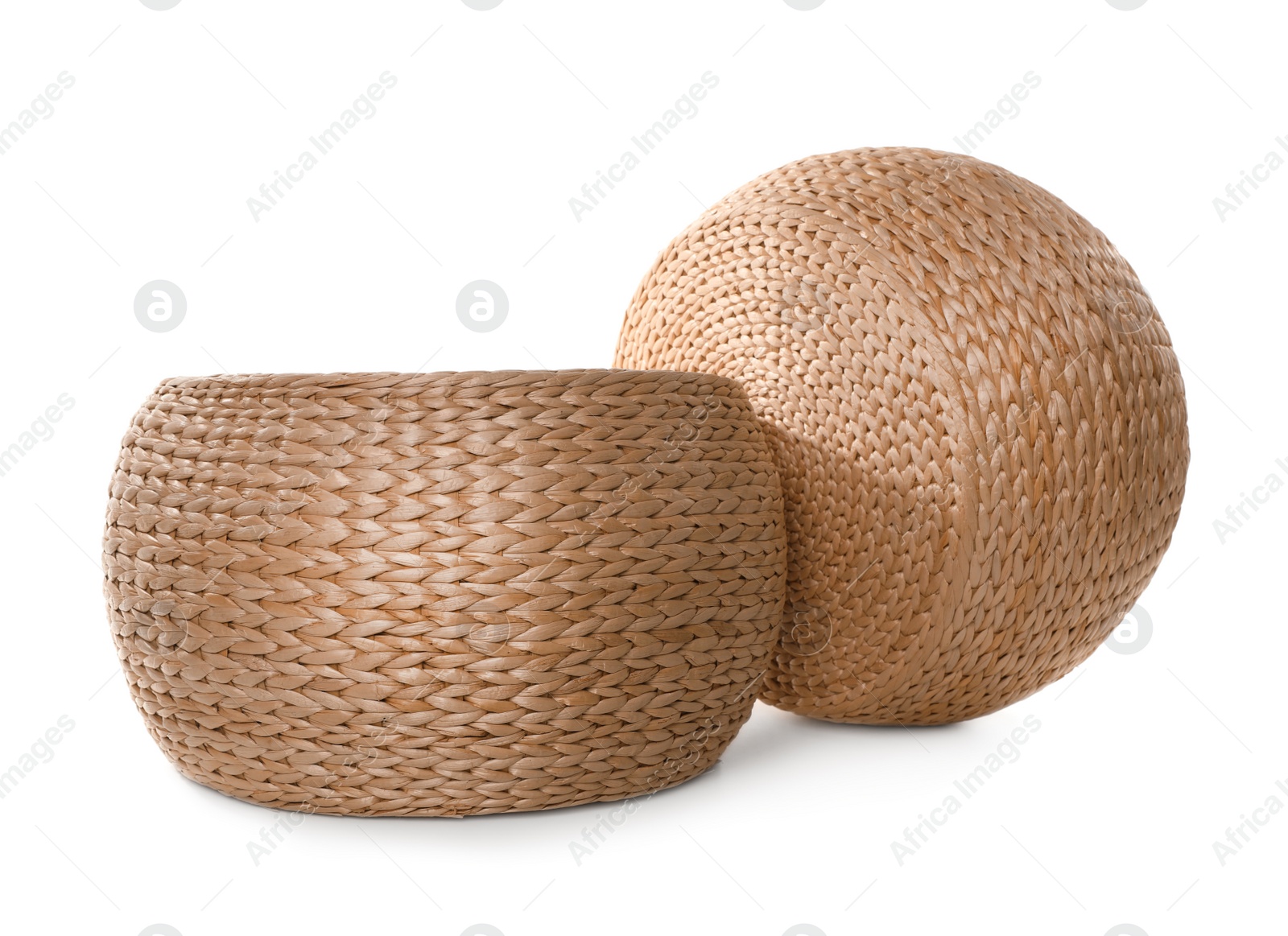 Photo of Two stylish wicker poufs on white background