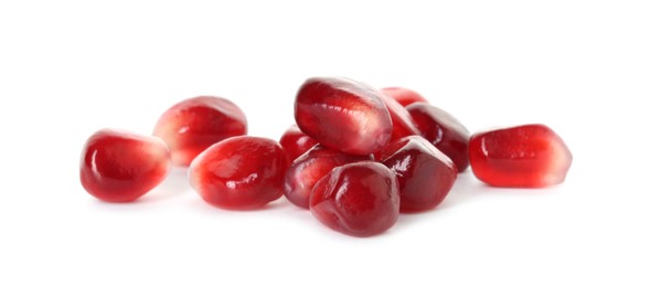 Photo of Pile of tasty pomegranate grains isolated on white