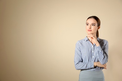 Portrait of young female teacher on beige background. Space for text