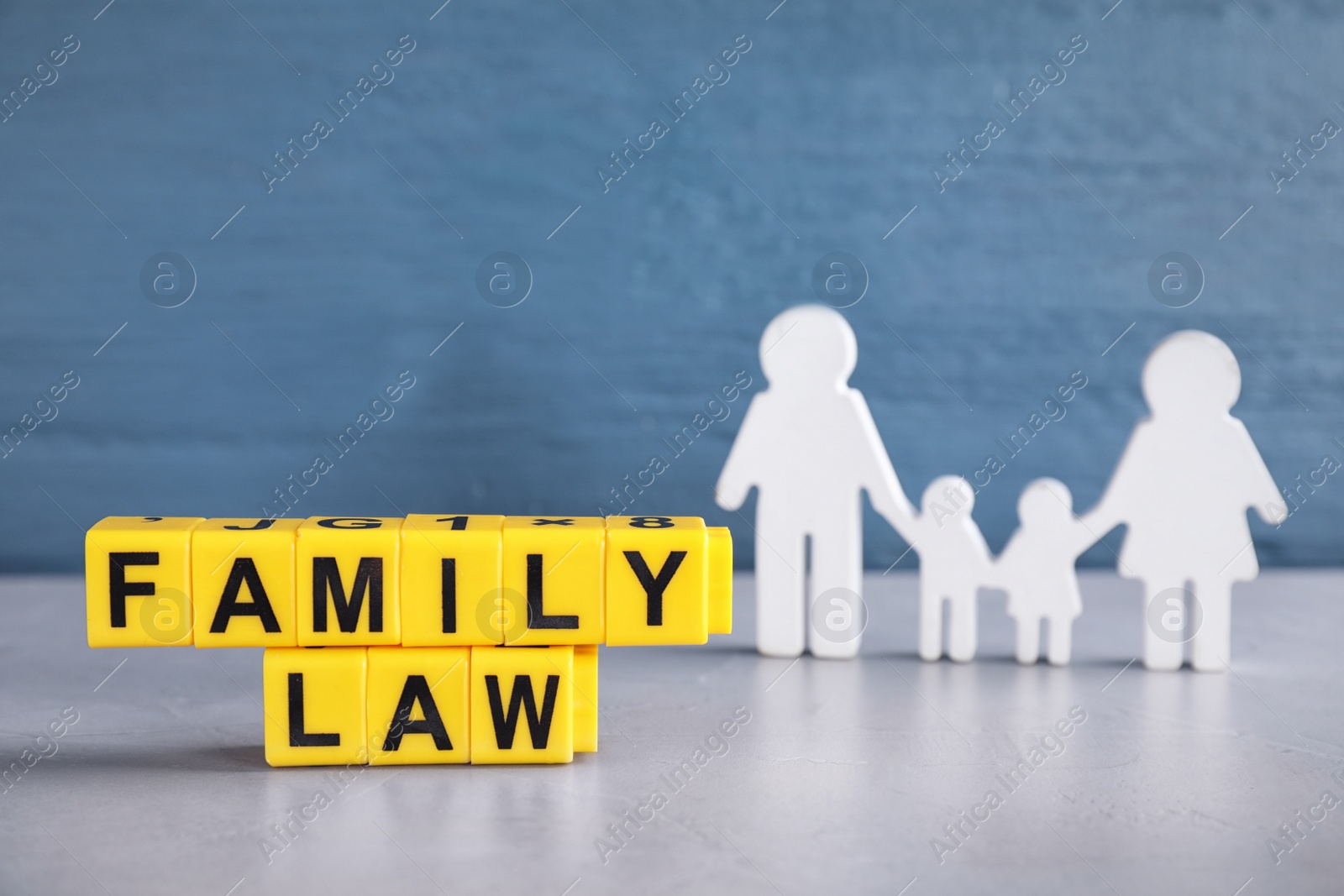 Image of Cubes with letters and family figure on light table. Family law concept