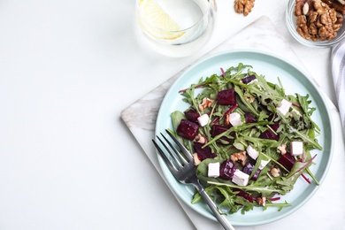 Fresh delicious beet salad on white table, flat lay. Space for text