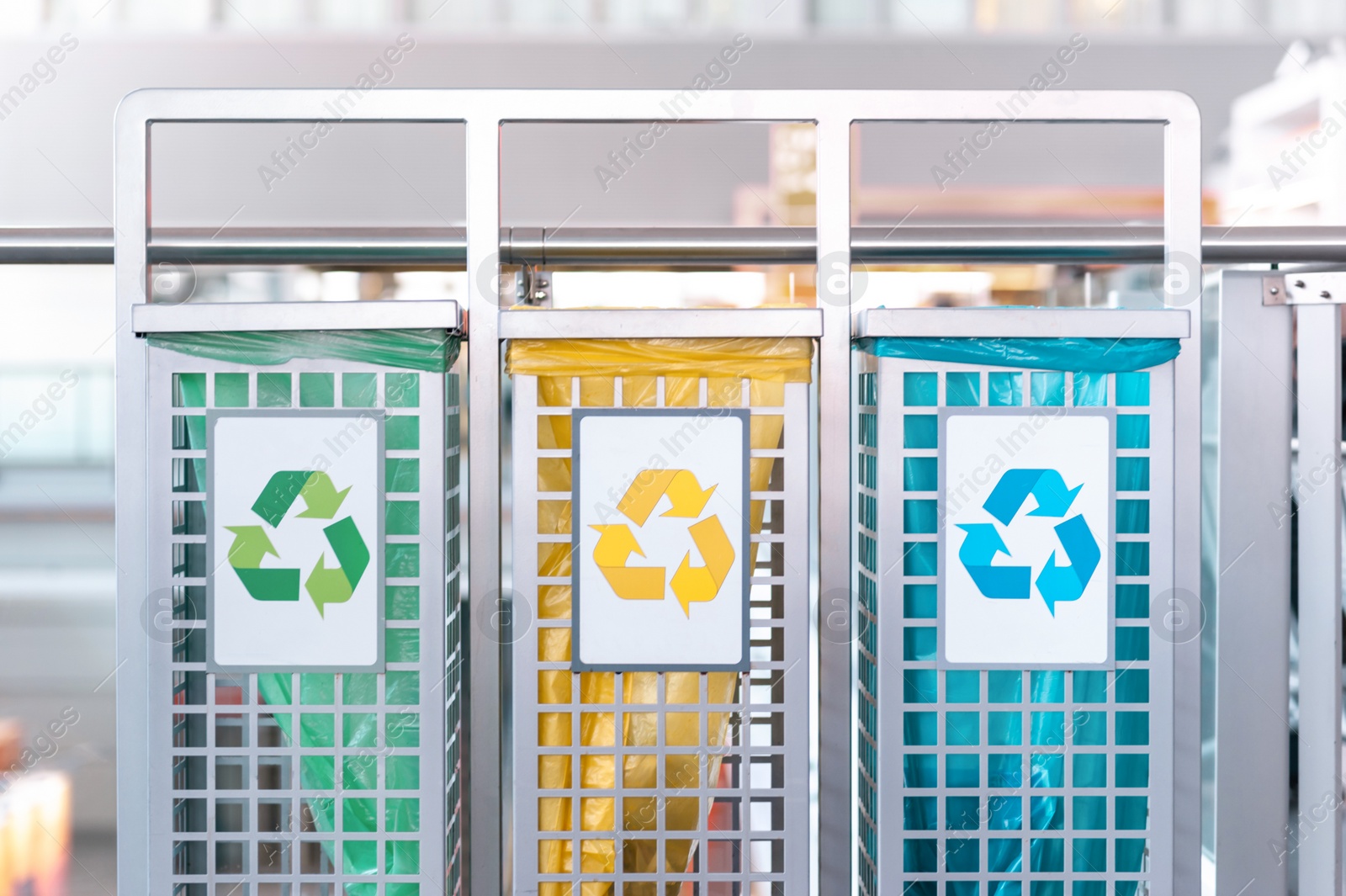 Photo of Color waste sorting bins indoors. Recycling concept