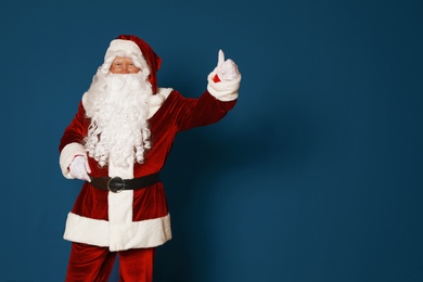 Photo of Authentic Santa Claus on blue background. Space for text