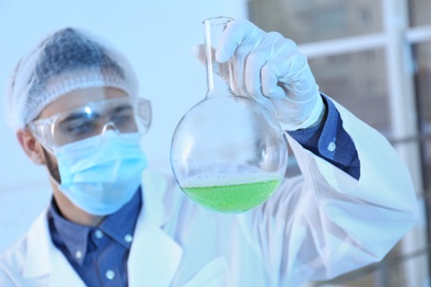 Photo of Young scientist working in laboratory. Chemical analysis