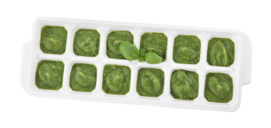 Photo of Puree in ice cube tray on white background, top view. Ready for freezing