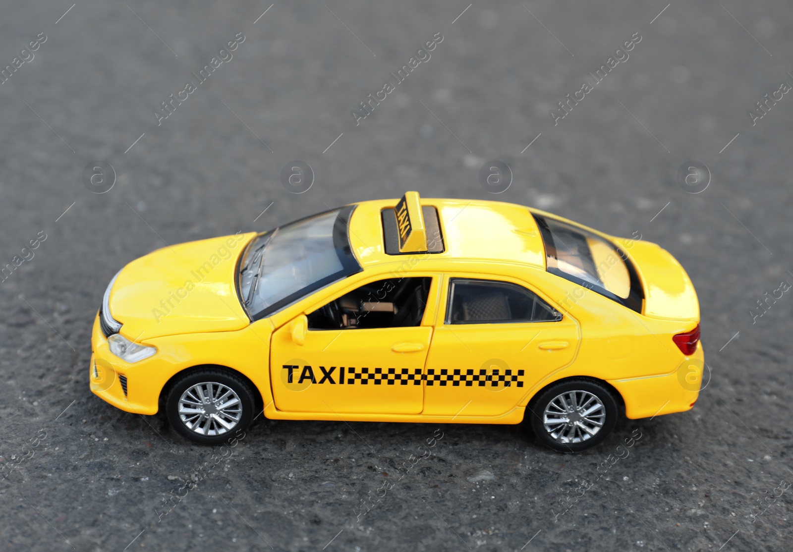 Photo of Yellow taxi car model on city street