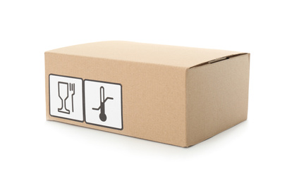 Photo of Cardboard box with different packaging symbols isolated on white. Parcel delivery