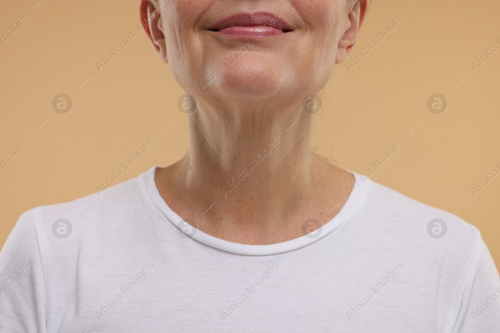 Photo of Mature woman with healthy skin on beige background, closeup