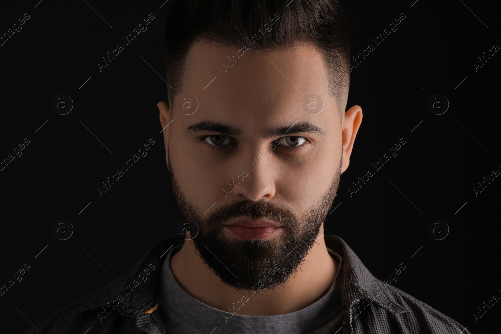 Photo of Evil eye. Man with scary eyes on black background