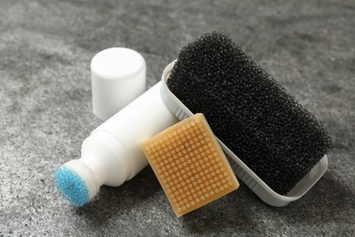 Composition with shoe care accessories on grey background, closeup