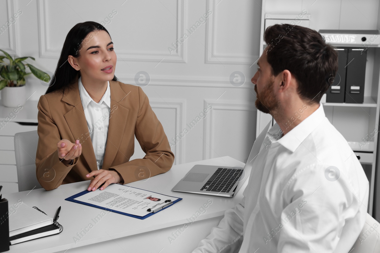 Photo of Human resources manager conducting job interview with applicant in office