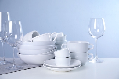 Photo of Set of clean tableware on light table