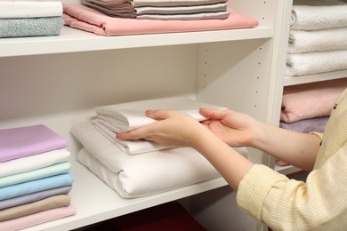Customer choosing bed linens in shop, closeup