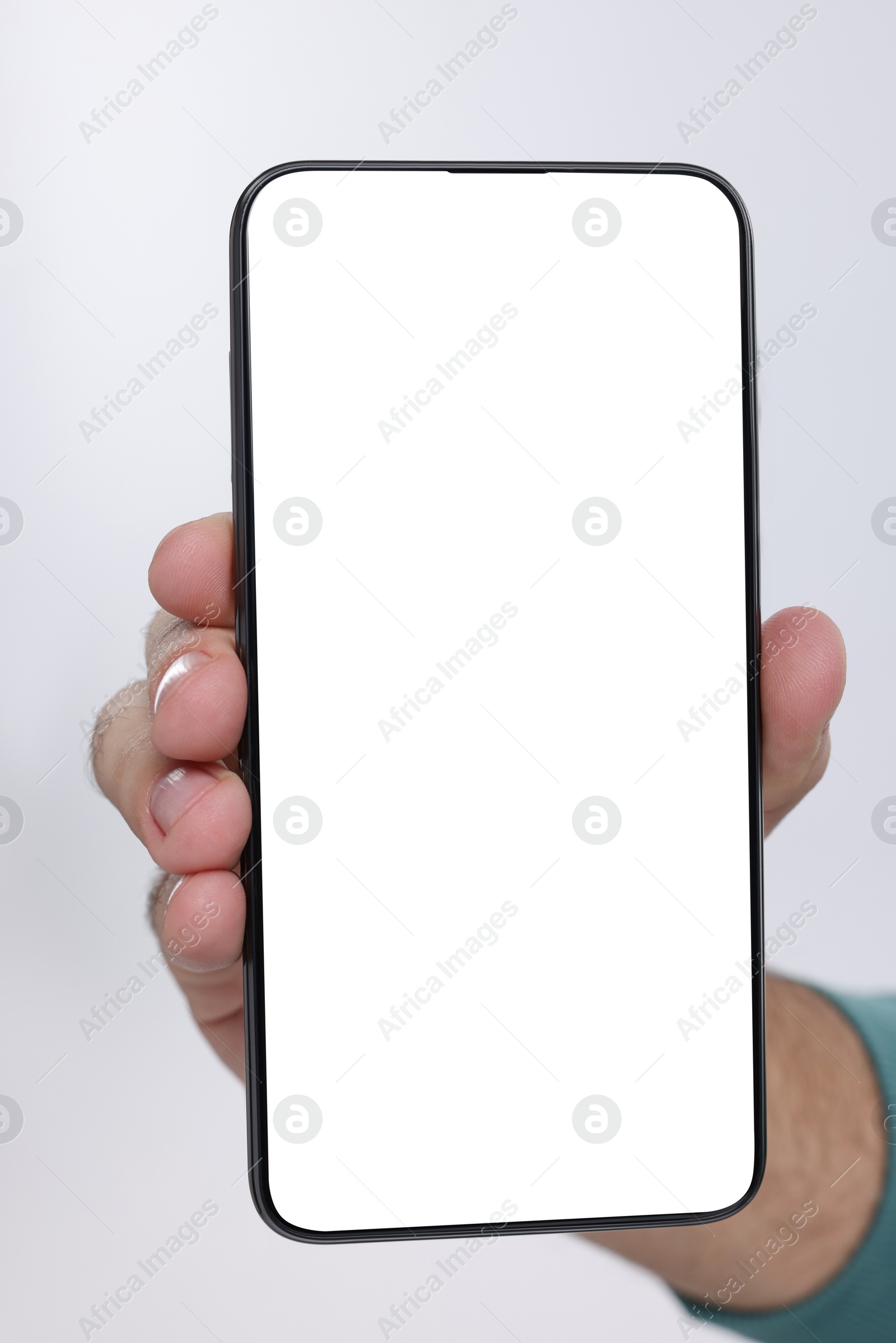 Photo of Man holding smartphone with blank screen on white background, closeup