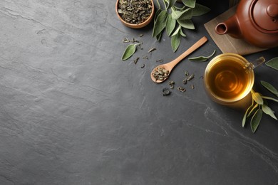 Photo of Flat lay composition with aromatic sage tea on black table. Space for text