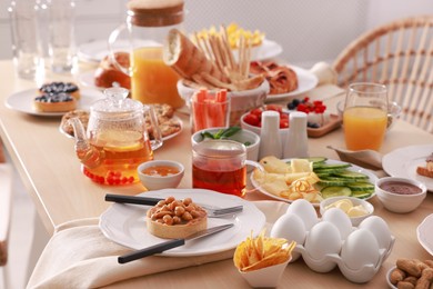 Photo of Dishes with different food on table indoors. Luxury brunch
