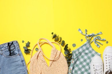 Set of stylish clothes on yellow background, flat lay. Space for text