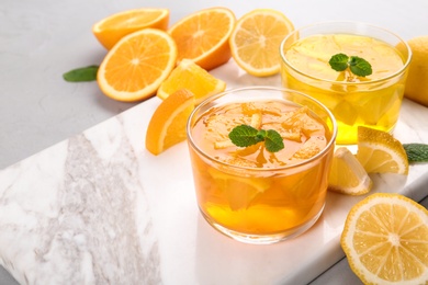 Photo of Glasses of tasty jelly served on light table. Space for text