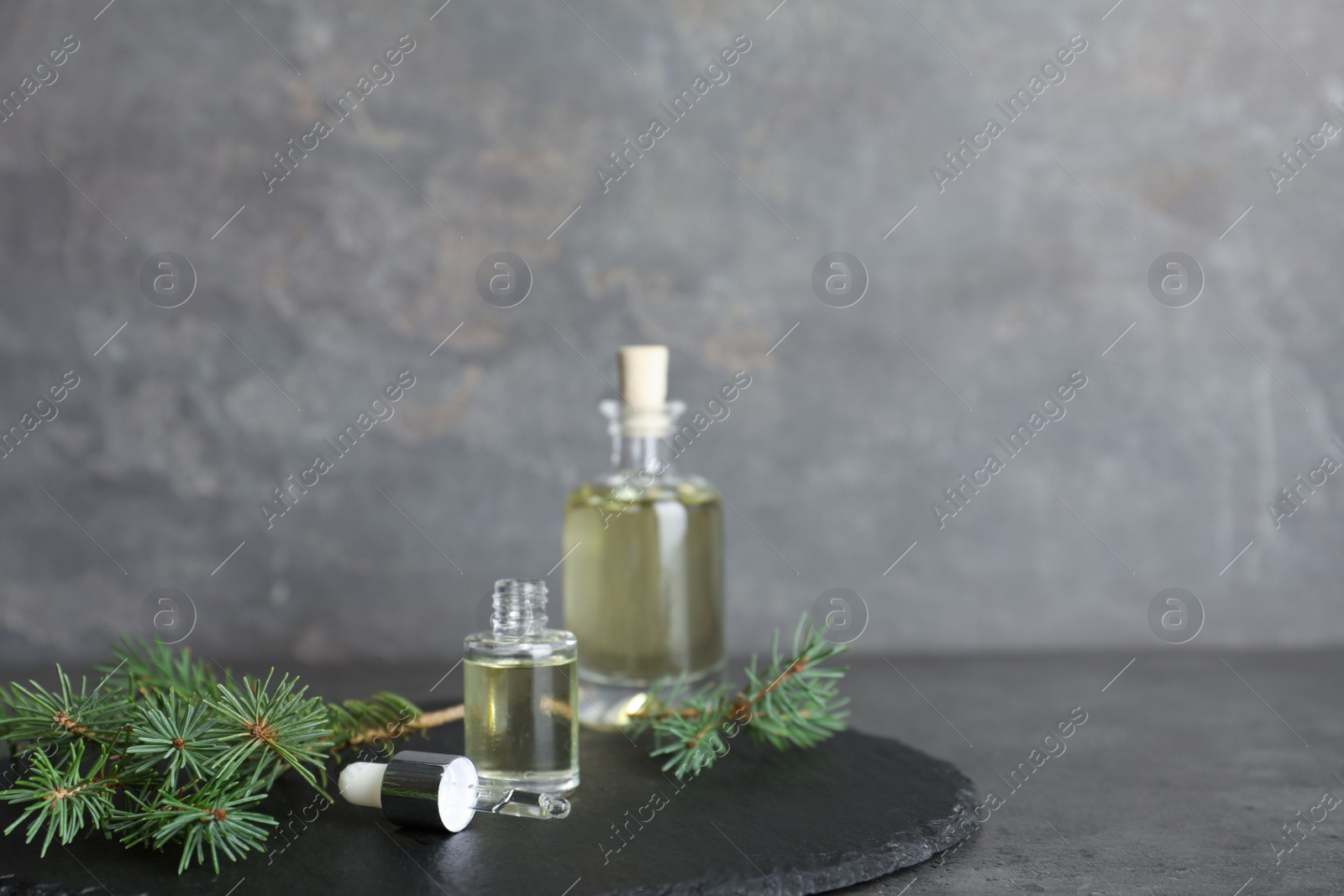 Photo of Composition with essential oil in glass bottles on table. Space for text