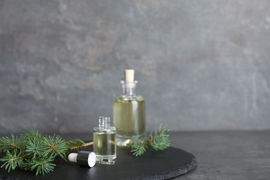 Composition with essential oil in glass bottles on table. Space for text