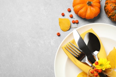 Photo of Seasonal table setting with pumpkins on light grey background, flat lay. Thanksgiving Day