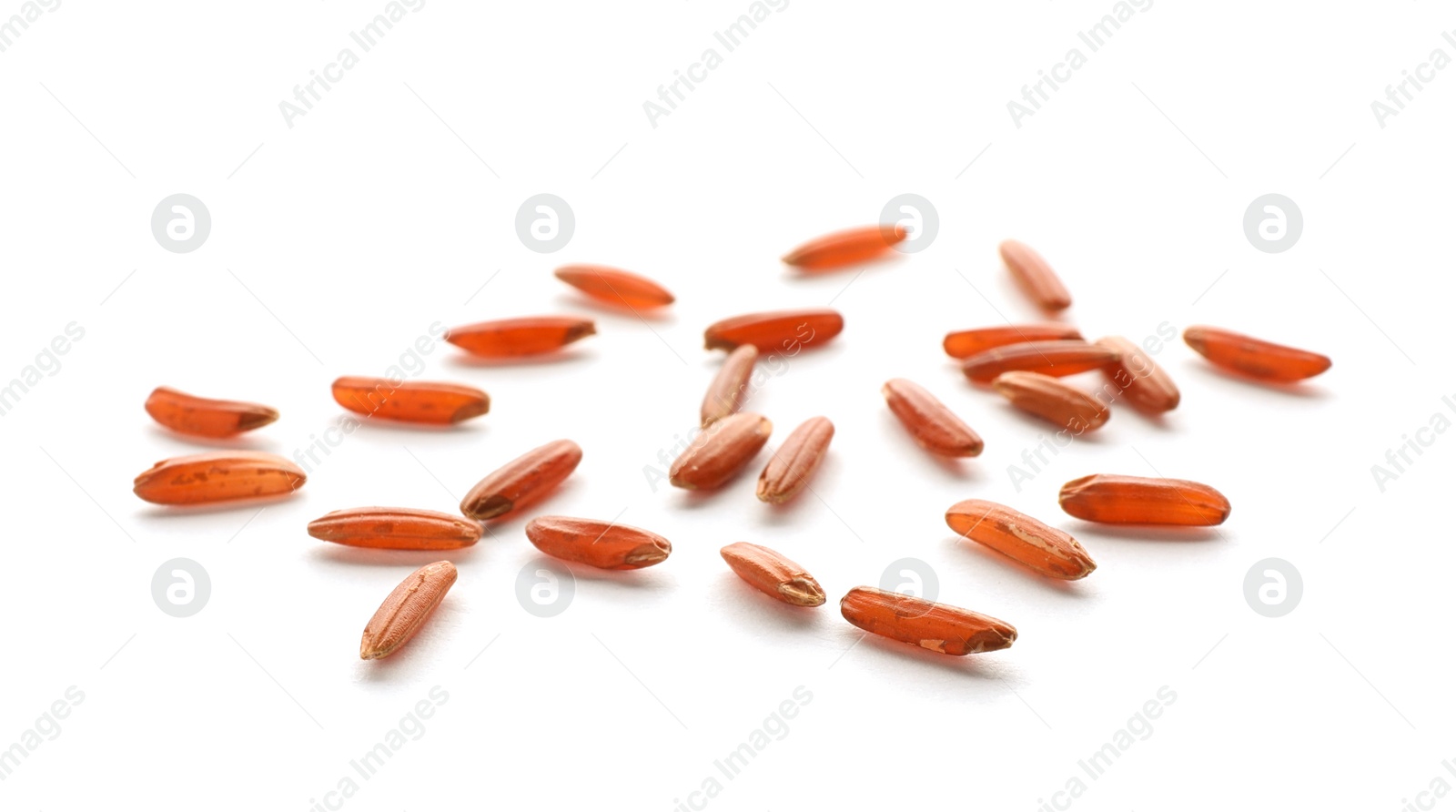 Photo of Scattered grains of brown rice on white background