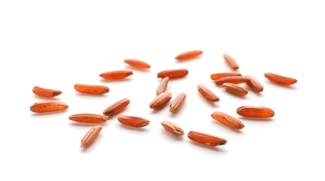 Photo of Scattered grains of brown rice on white background