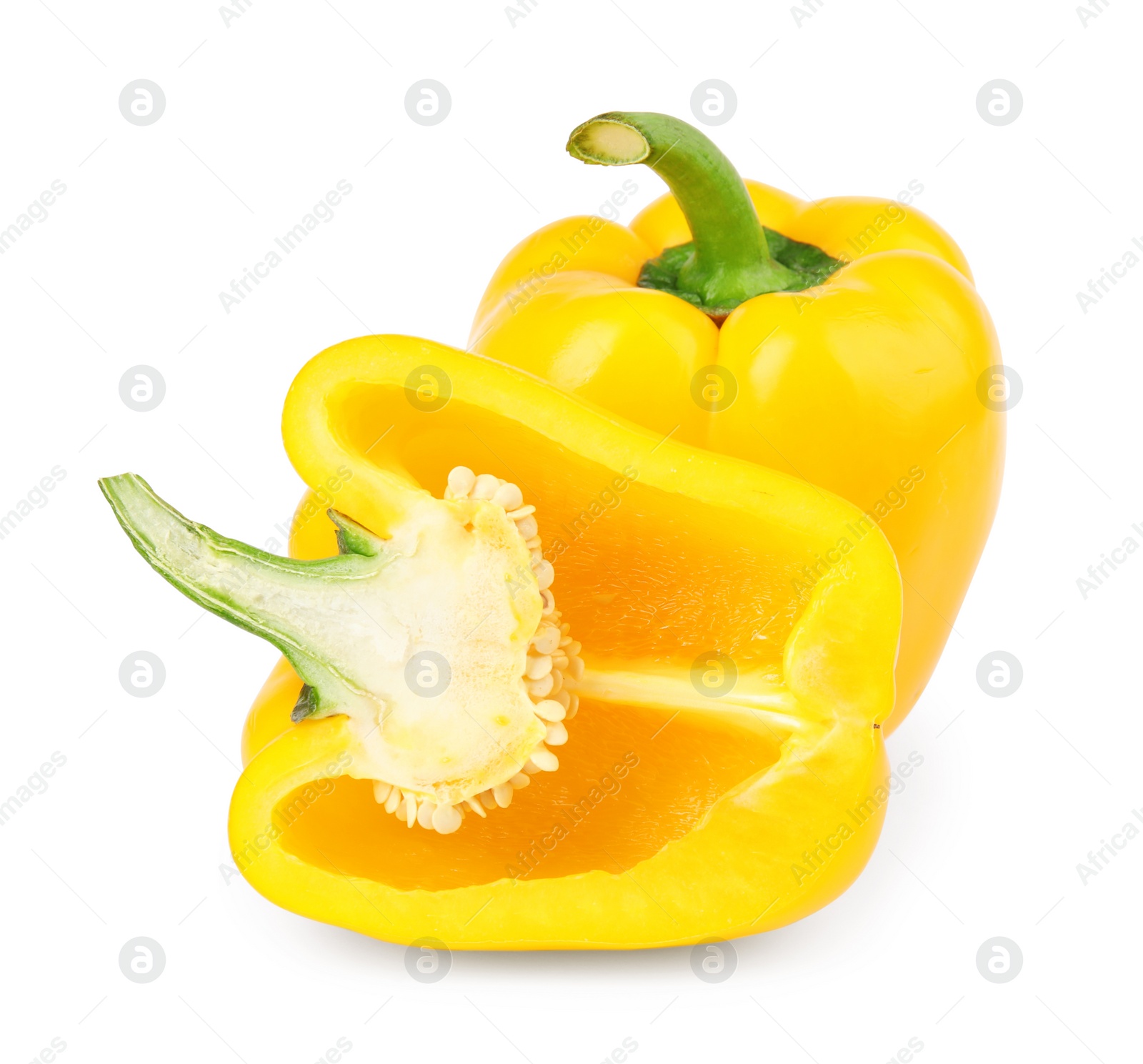 Photo of Whole and cut yellow bell peppers isolated on white