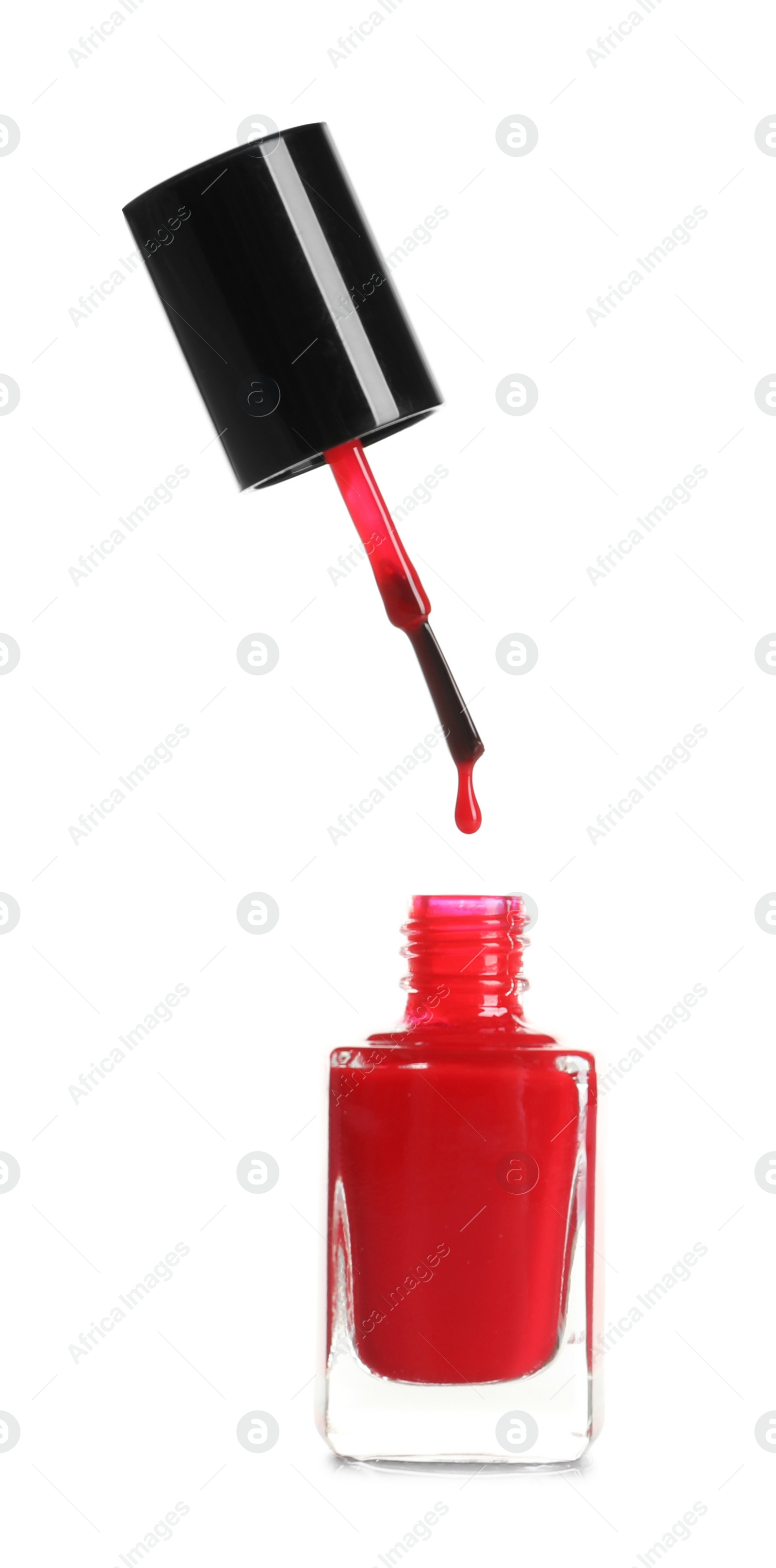 Photo of Brush over nail polish bottle on white background