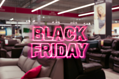 Blurred view of furniture store in mall. Black Friday Sale