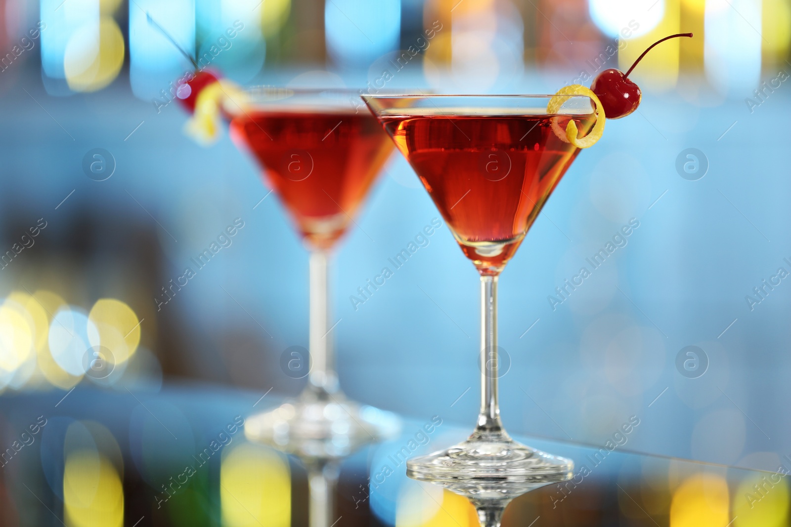 Photo of Glasses of fresh alcoholic cocktail on bar counter